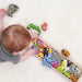 Photo of BeginAgain Animal Parade A to Z Puzzle from above with a child playing with the toy